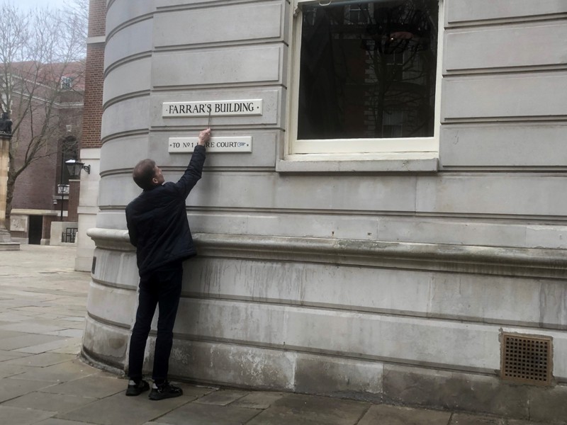 Liam outside Farrar's Building reviewing their signage as part of an access audit. 