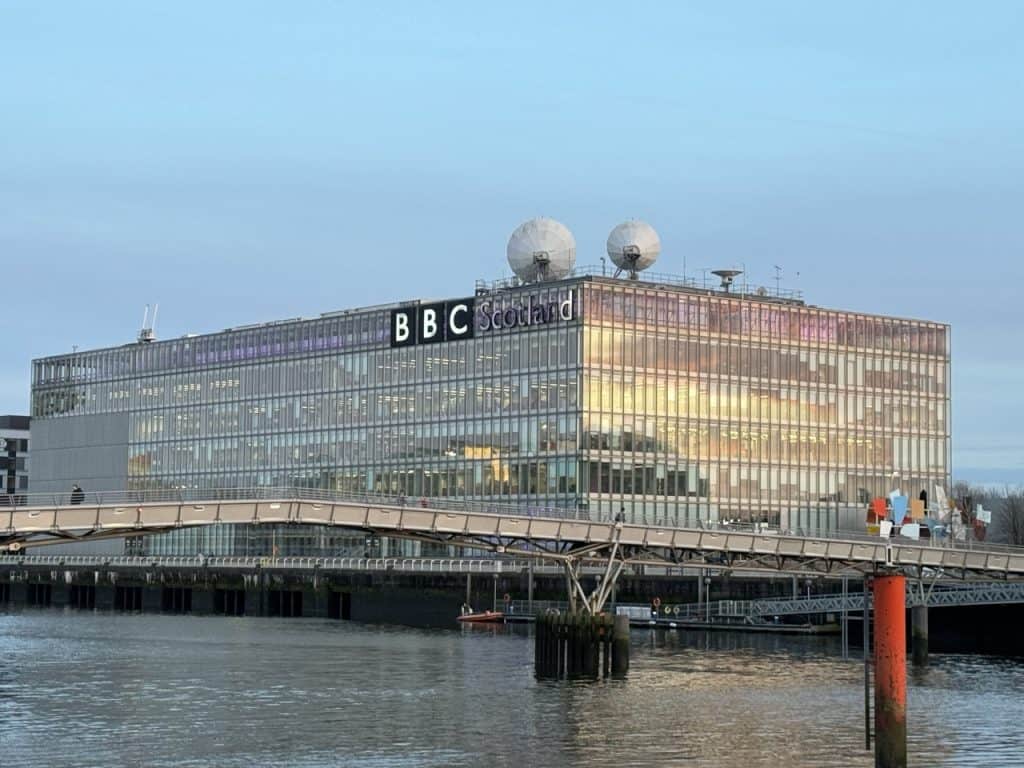 View of the BBC Scotland building with a river and bridge in front of it.