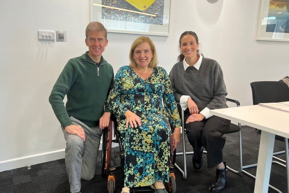A photo of Liam Proudlock, Tracey Proudlock and Regina Bortoni. They are all sat facing the camera and smiling.