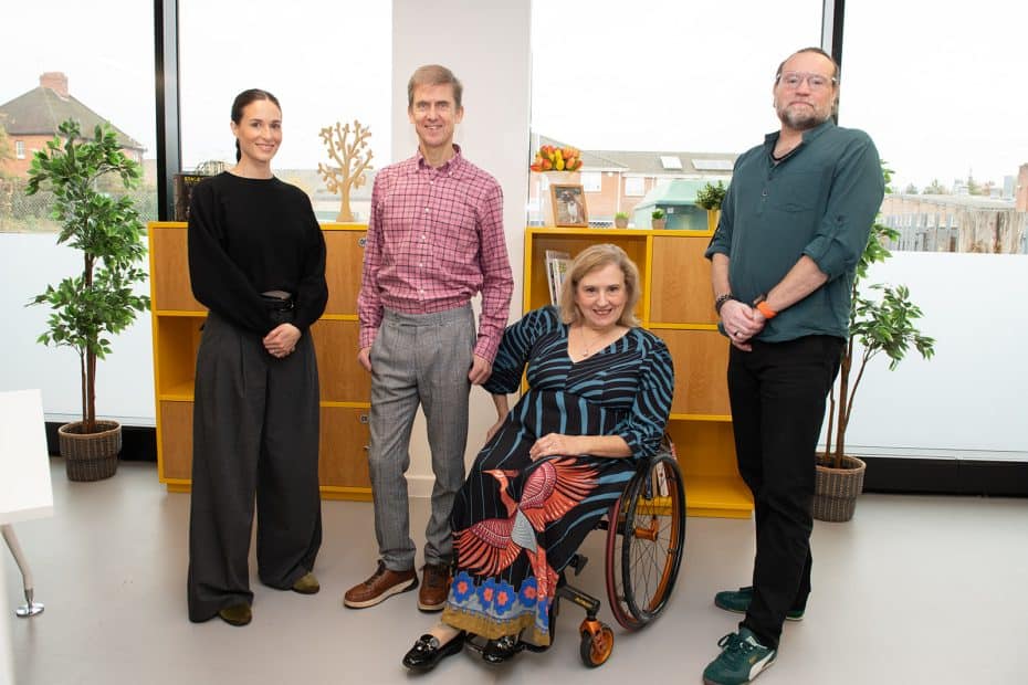 A photograph of the team at Proudlock Associates taken in an office with furniture and a window as the background. From left to right: Regina, Liam, Tracey and Richard